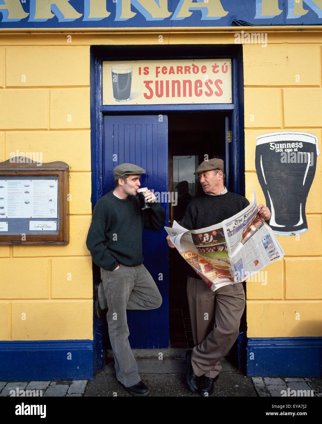 Dingle Town,Co Kerry,Ireland;Men Standing Outside Pub Stock Photo