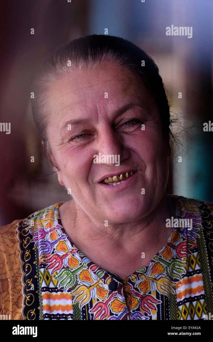 A woman with gold capped teeth in Azerbaijan. Replacing natural teeth with gold implants or caps was once a status symbol and prestige in Central Asia. Stock Photo