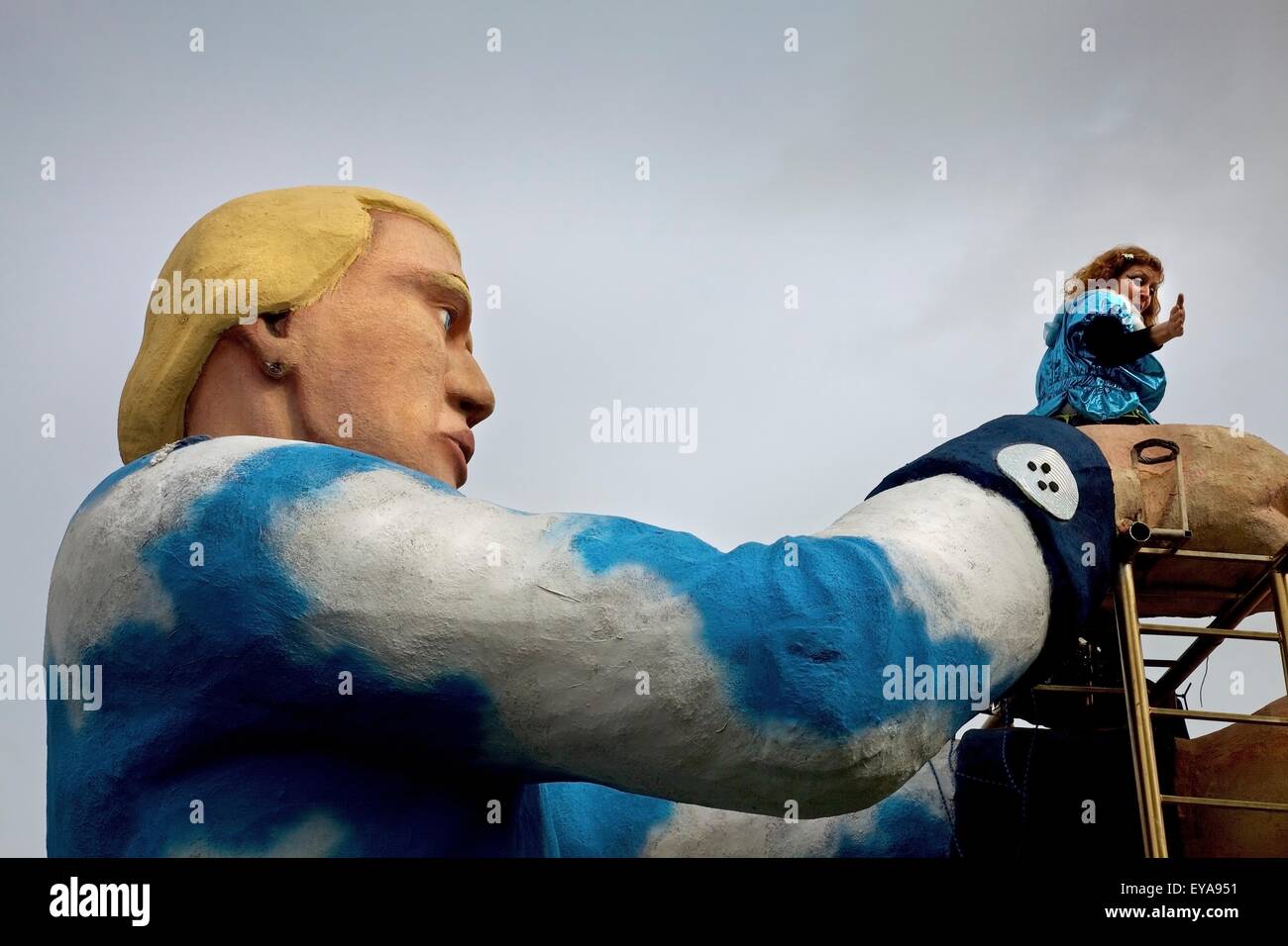 Dublin, Ireland; A Woman Dancing On Top Of A Giant Man Statue In A