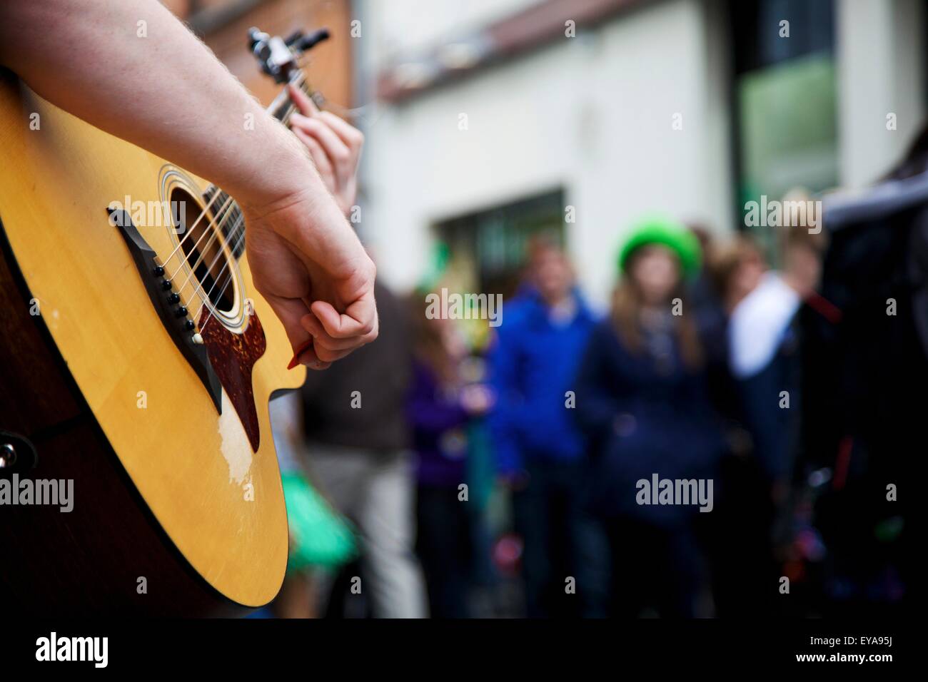 Dublin, Ireland; A Musician Plays His Guitar In The Street Stock Photo