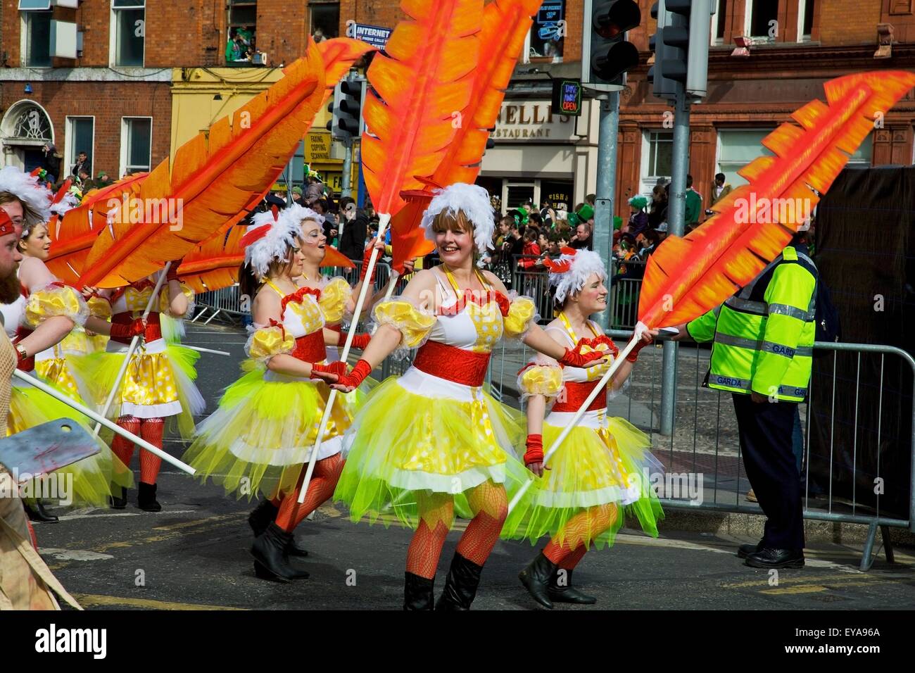 Dublin, Ireland; Women In Costume Dance With Large Feathers As Part Of