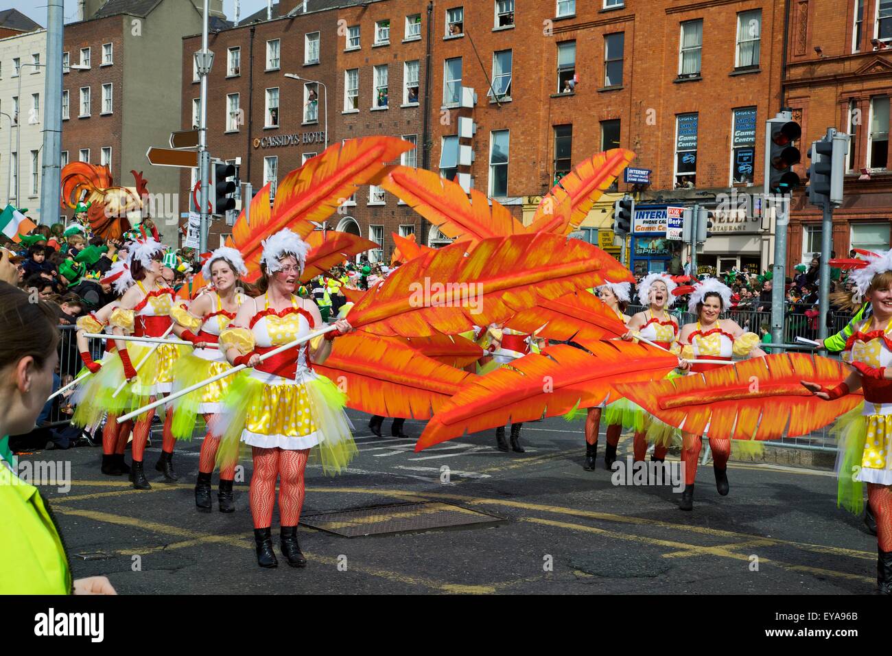 Dublin, Ireland; Women In Costume Dance With Large Feathers As Part Of