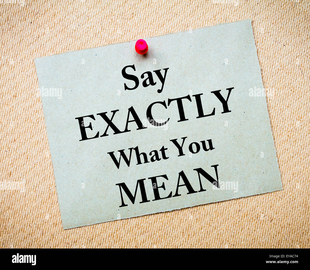 Say Exactly What You Mean Message written on recycled paper note pinned on cork board