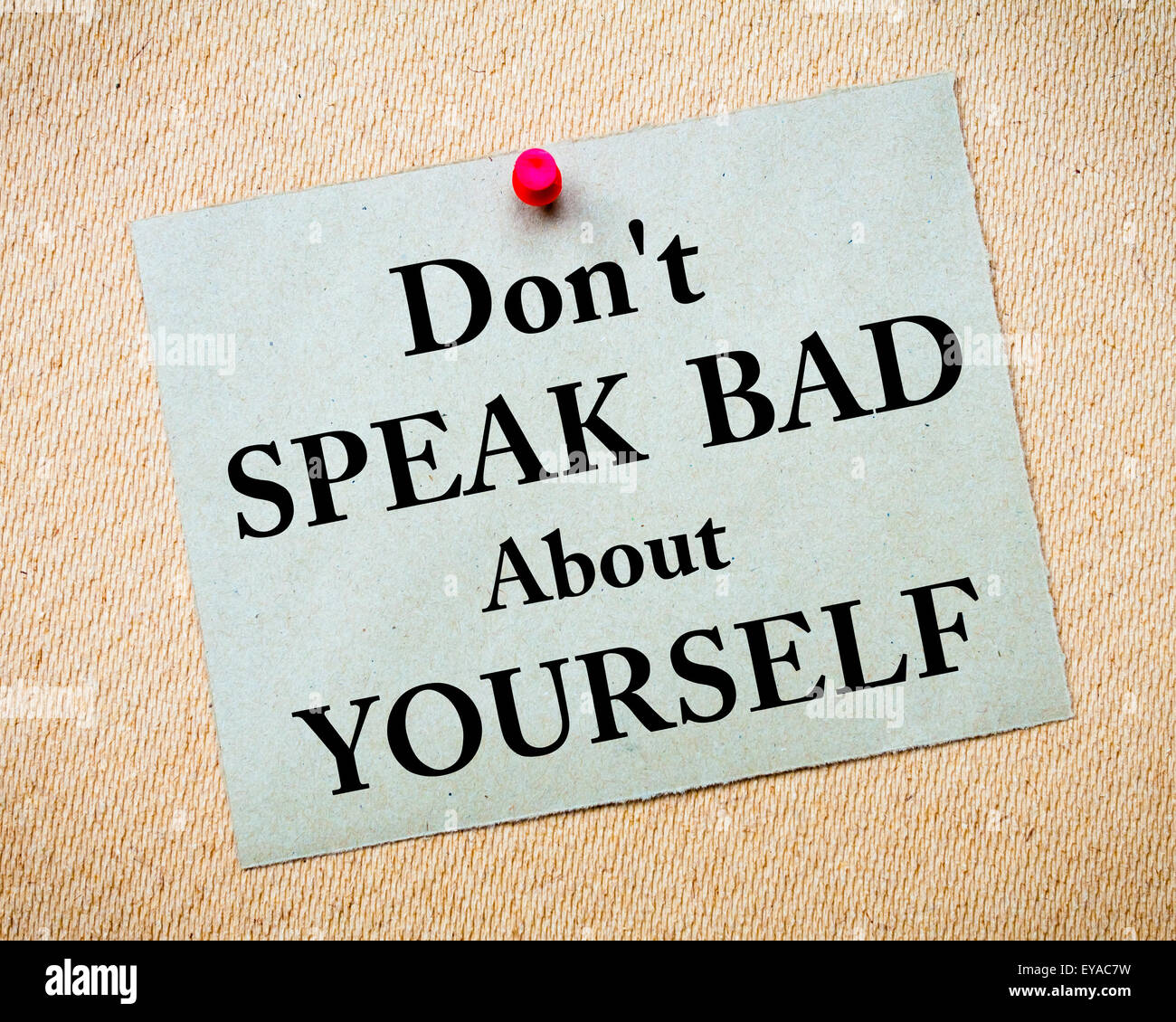 Don't Speak Bad About Yourself  Message written on recycled paper note pinned on cork board. Motivational concept Image Stock Photo