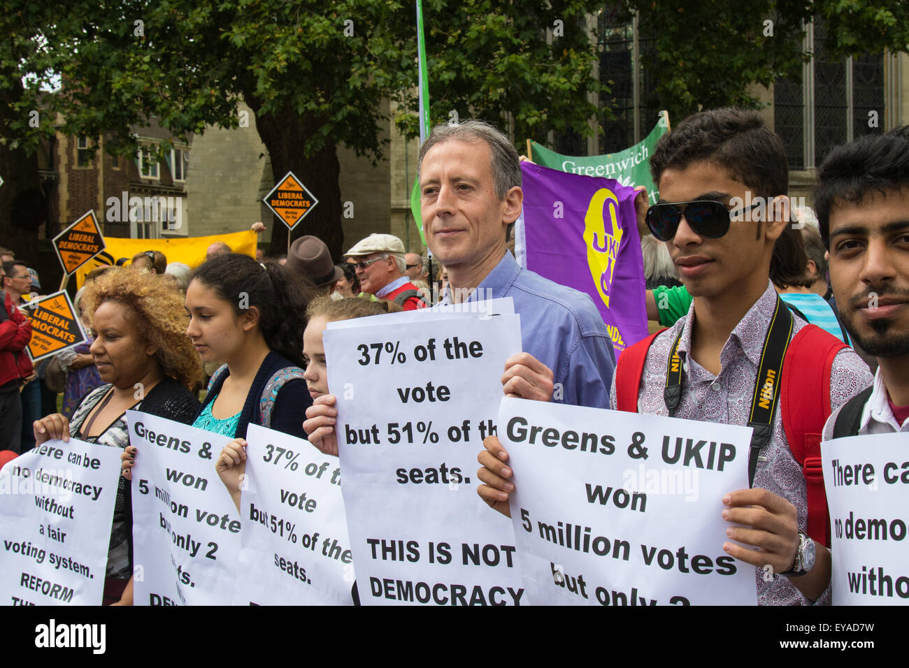London, UK. 25th July, 2015. Protesters gather outside the Houses of Parliament to demand electoral reform, including proportional representation rather than the first-past-the-post method that saw the Tories gain a majority. PICTURED: Gay and human rights activist Peter Tatchell, centre, is one of many influential people calling for electoral reform. Credit:  Paul Davey/Alamy Live News Stock Photo