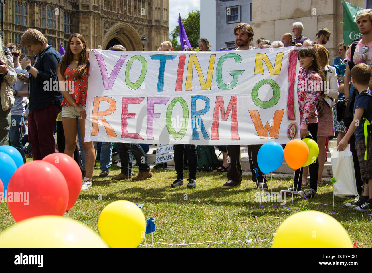 London, UK. 25th July, 2015. Protesters gather outside the Houses of Parliament to demand electoral reform, including proportional representation rather than the first-past-the-post method that saw the Tories gain a majority. Credit:  Paul Davey/Alamy Live News Stock Photo