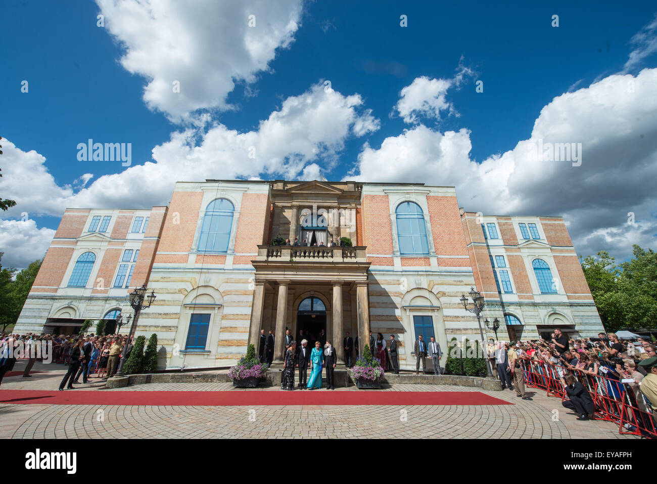 Bayreuth, Germany. 25th July, 2015. German Chancellor Angela Merkel (CDU, 3-L), her husband Joachim Sauer (R), Bayreuth's mayor Brigitte Merk-Erbe and husband Thomas Erbe (2-L) arrive for the opening of the 104th Bayreuth Festival at the Richard-Wagner-Festspielhaus (Bayreuth Festspielhaus), in Bayreuth, Germany, 25 July 2015. The Richard Wagner festival opens with the opera 'Tristan und Isolde' (Tristan and Iseult) and runs until 28 August. Photo: ARMIN WEIGEL/dpa/Alamy Live News Stock Photo