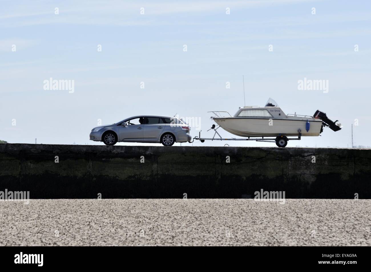 Car towing boat and trailer up the Knott End launching ramp Stock Photo