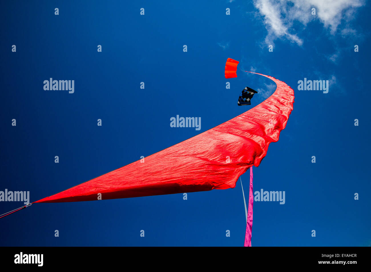 Colourful; curved flying kite sail in the skies at Lytham Stock Photo