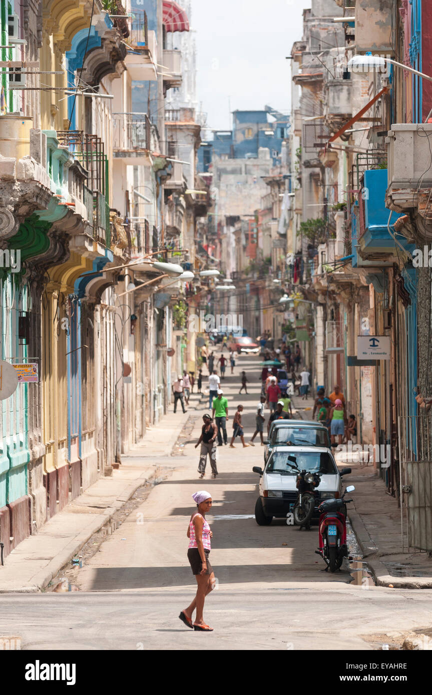 HAVANA, CUBA - JUNE, 2011: More pedestrians than cars fill a long street in Central Havana. Stock Photo