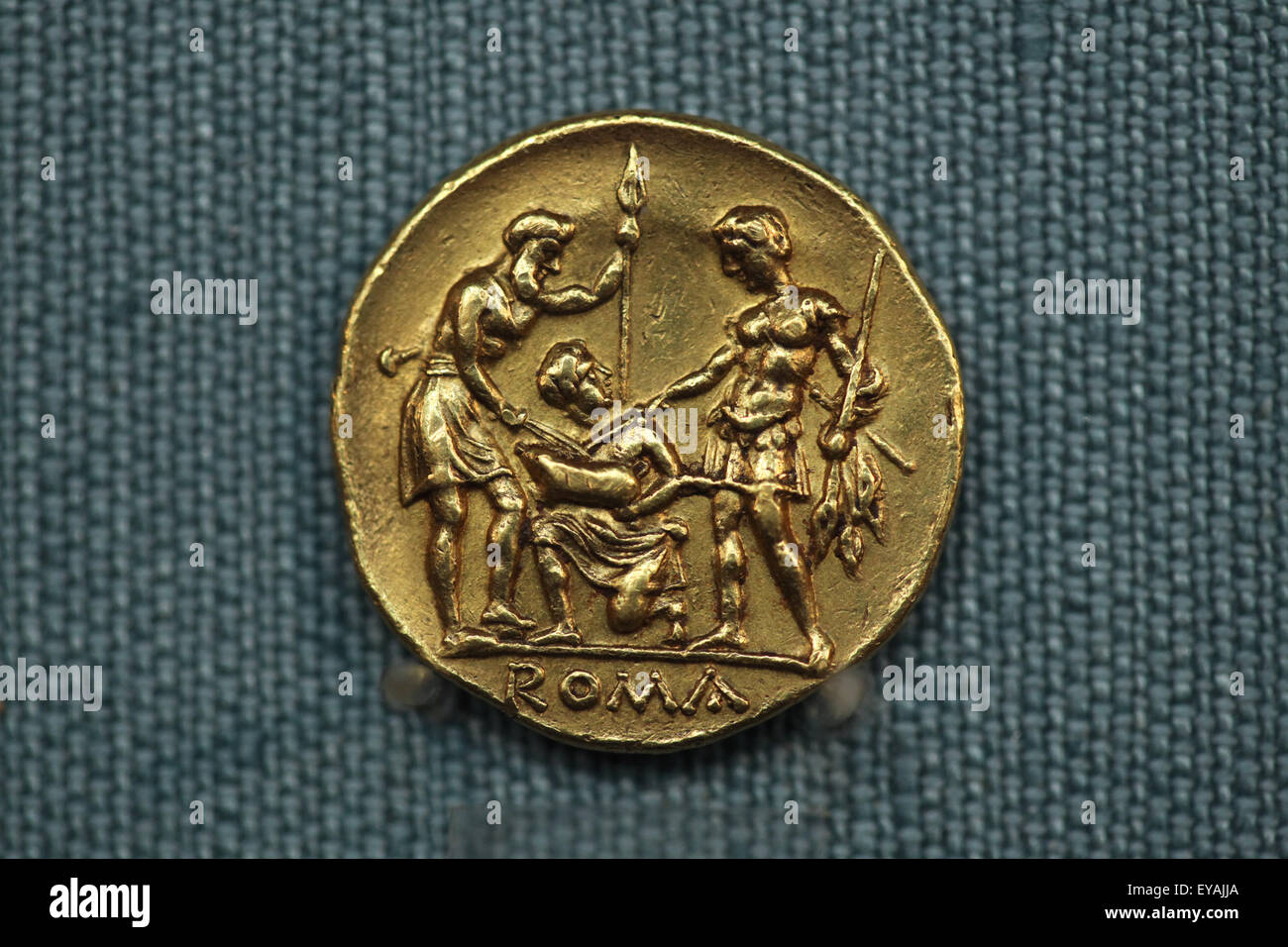 Roman golden stater. Extremely rare Roman republican golden coin issued after the First Punic War from 225-212 BC. Kunsthistorisches Museum, Vienna, Austria. Oath scene with two warriors, one Roman and the other representing the Italian allies, standing facing each other, holding spears and touching with their swords a sacrificial pig held by a figure kneeling between them. The meaning of this scene is clear: Rome demonstrates to her allies that the war against Carthage is a cooperative effort. This was the first Roman coin in gold. Stock Photo