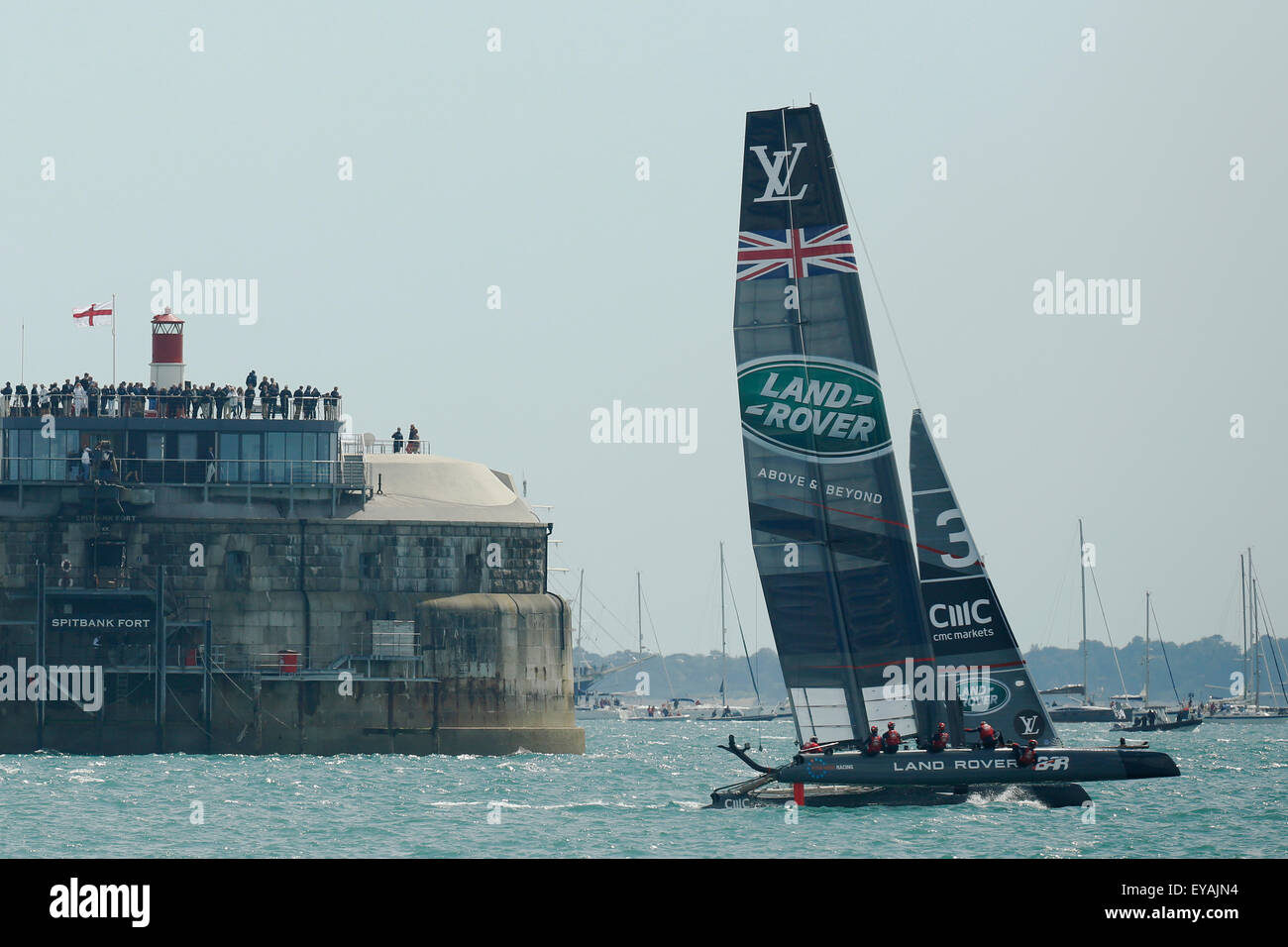 Portsmouth, UK. 25th July, 2015. Britain's Land Rover BAR (Ben Ainslie Racing) passes SPitbank Fort as they compete in the first official race of the 35th America's Cup World Series Races at Portsmouth in Hampshire, UK Saturday July 25, 2015. The 2015 Portsmouth racing of the Louis Vuitton America's Cup World Series counts towards the qualifiers and playoffs which determine the challenger to compete against the title holders Oracle Team USA in 2017. Credit:  Luke MacGregor/Alamy Live News Stock Photo