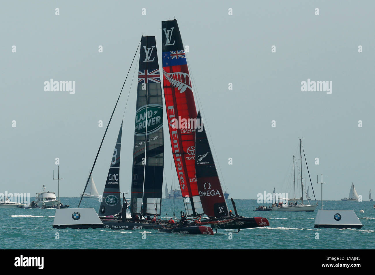 Portsmouth, UK. 25th July, 2015. Teams: Emirates New Zealand (R) and Britain's Land Rover BAR (Ben Ainslie Racing) compete in the first official race of the 35th America's Cup World Series Races at Portsmouth in Hampshire, UK Saturday July 25, 2015. The 2015 Portsmouth racing of the Louis Vuitton America's Cup World Series counts towards the qualifiers and playoffs which determine the challenger to compete against the title holders Oracle Team USA in 2017. Credit:  Luke MacGregor/Alamy Live News Stock Photo
