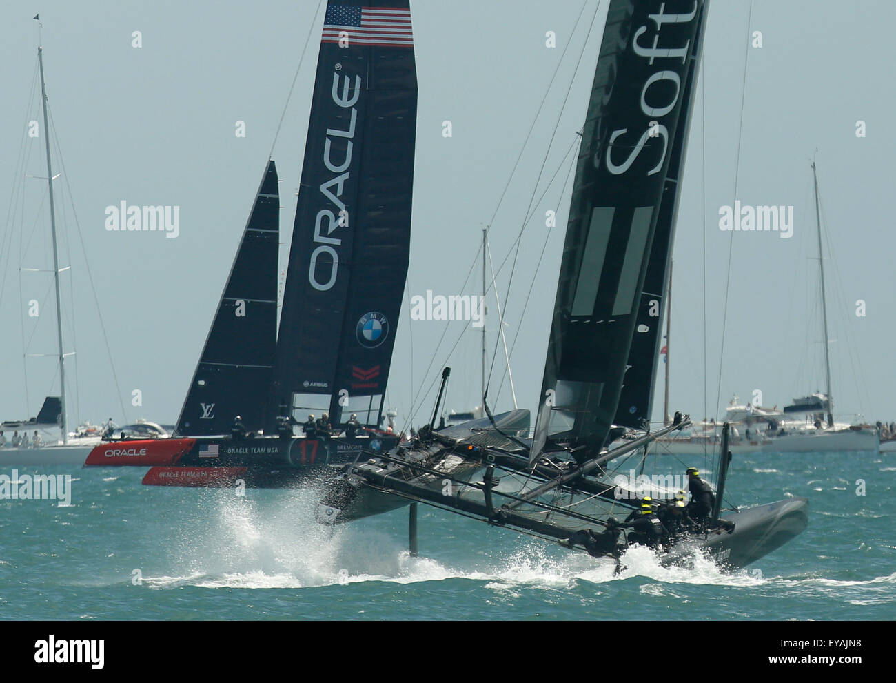 Portsmouth, UK. 25th July, 2015. Participating teams (L-R) Oracle Team USA and SoftBank Team Japan compete in the first official race of the 35th America's Cup World Series Races at Portsmouth in Hampshire, UK Saturday July 25, 2015. The 2015 Portsmouth racing of the Louis Vuitton America's Cup World Series counts towards the qualifiers and playoffs which determine the challenger to compete against the title holders Oracle Team USA in 2017. Credit:  Luke MacGregor/Alamy Live News Stock Photo