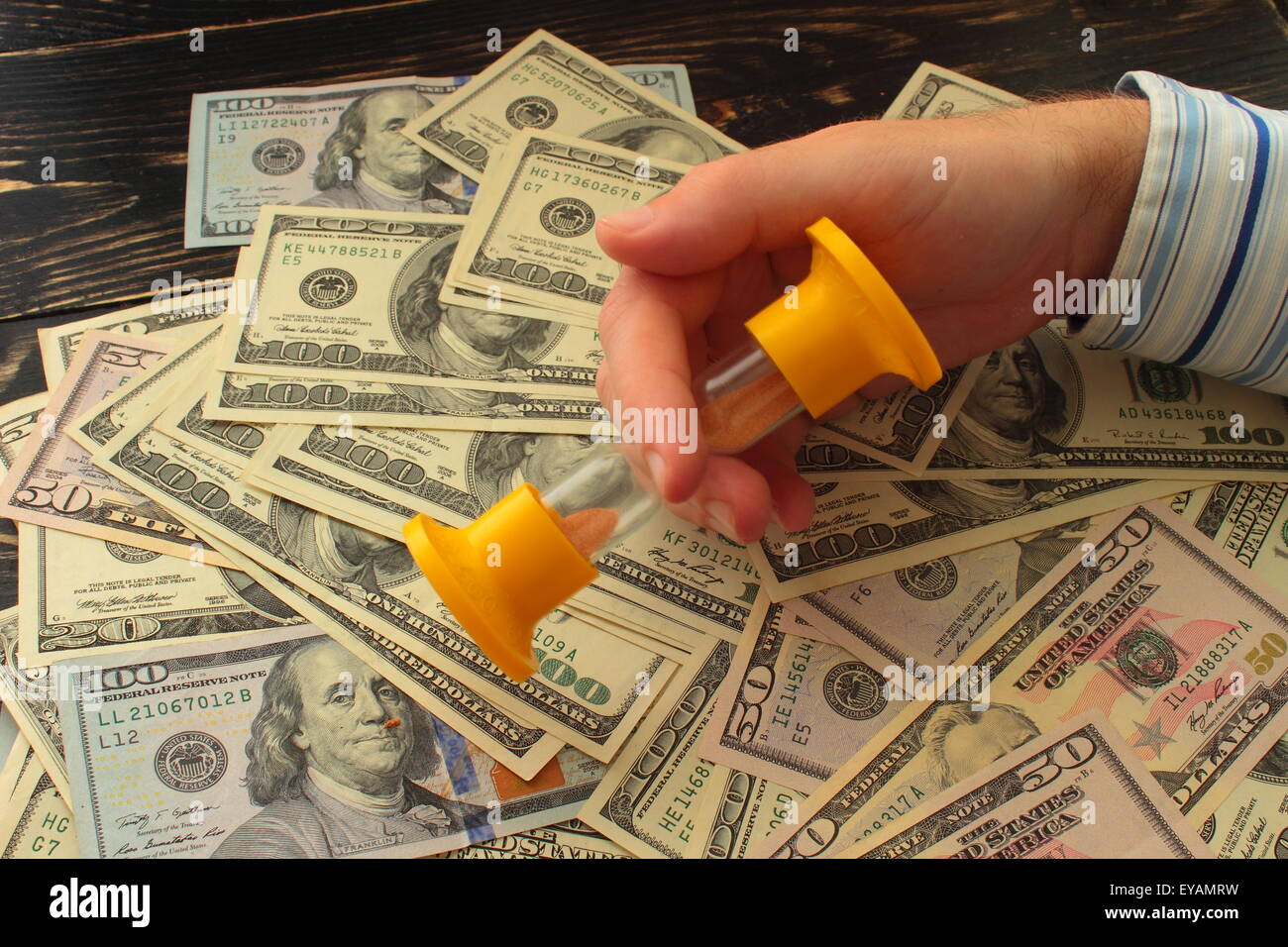 lie dollars and are in the hands of the hourglass time business hour hourglass closeup sig Stock Photo
