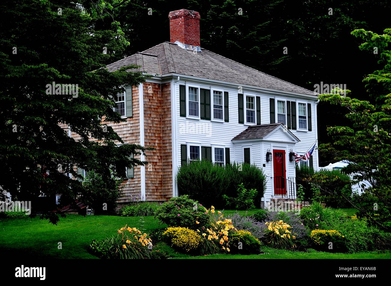 Sandwich, Massachusetts:  Handsome c. 1750 colonial home with hip roof, center chimney, Summer and flower gardens Stock Photo