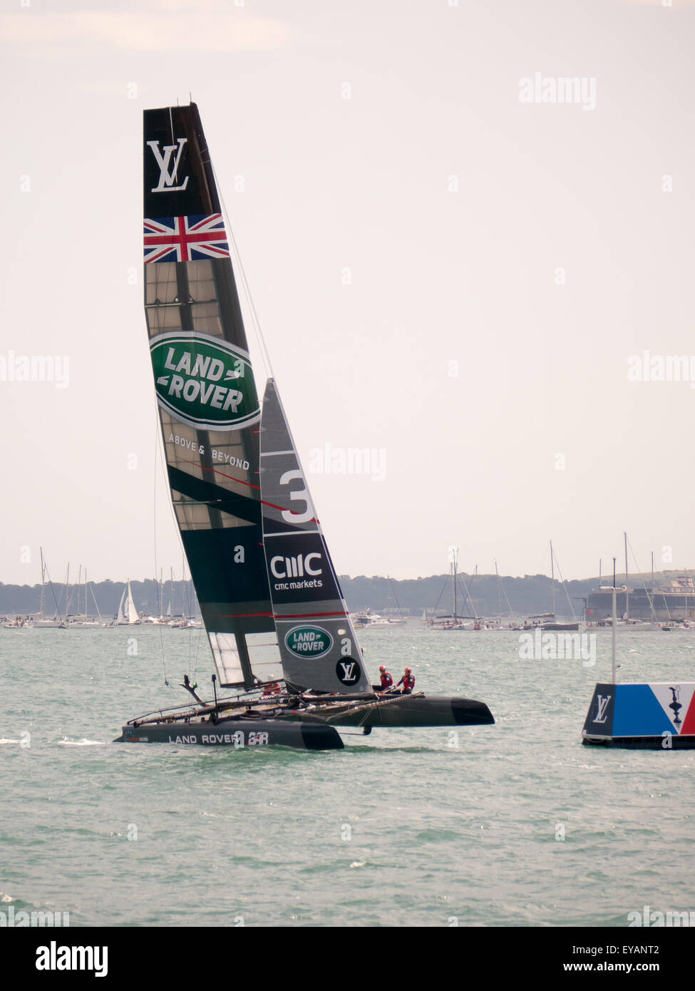 Portsmouth, England, July 25th 2015. The catamaran of Ben Ainslie racing crosses the finsih line in second place at the end of the second race of the Americas Cup World Series in Portsmouth. The Americas Cup World Series takes place in Portsmouth between the 23 July and the 26th July 2015 Credit:  simon evans/Alamy Live News Stock Photo