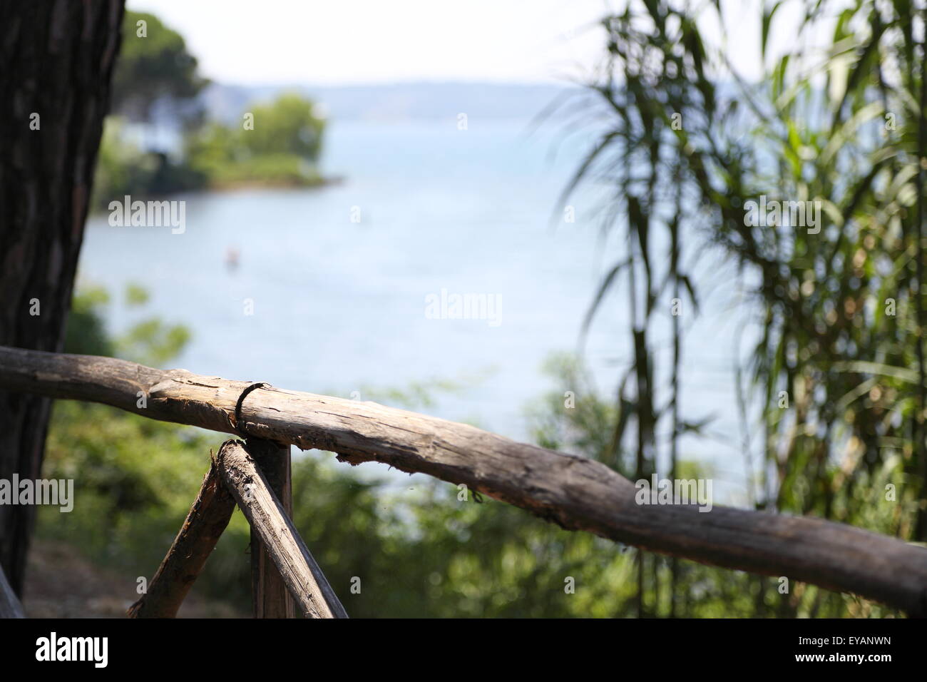 Fence on the shore of a lake with blurred background Stock Photo - Alamy