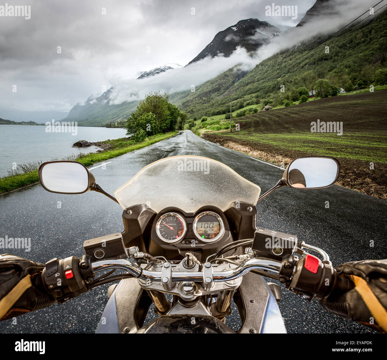 Biker rides a motorcycle in the rain. First-person view Stock Photo - Alamy