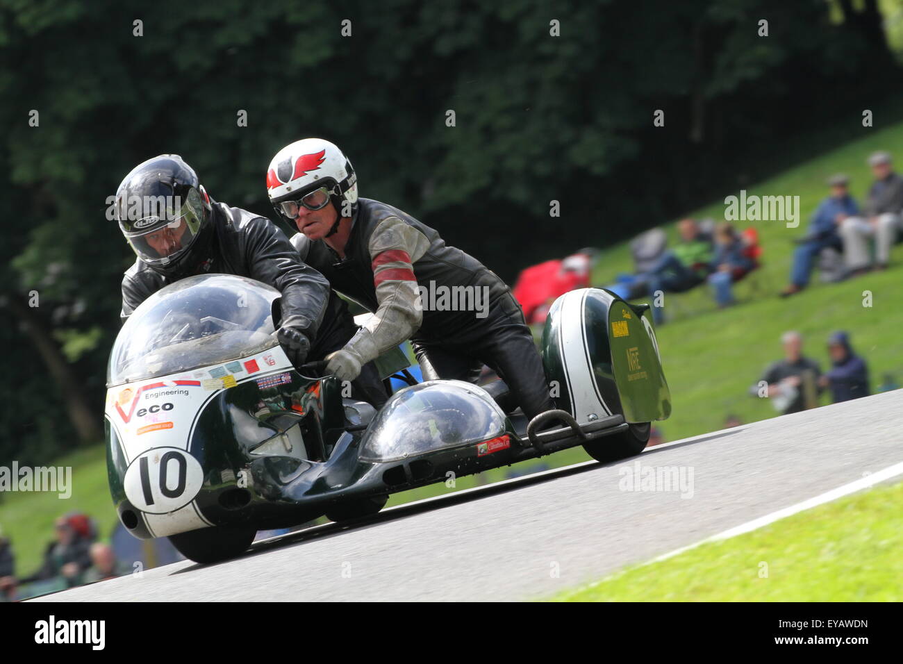 Sidecar racing was amongst the spectacles as classic bike fans from around the globe are gather this weekend at the historic Cadwell Park motor racing circuit in Lincolnshire UK to witness the greatest gathering of historic racing motorcycles in recent history. Stock Photo