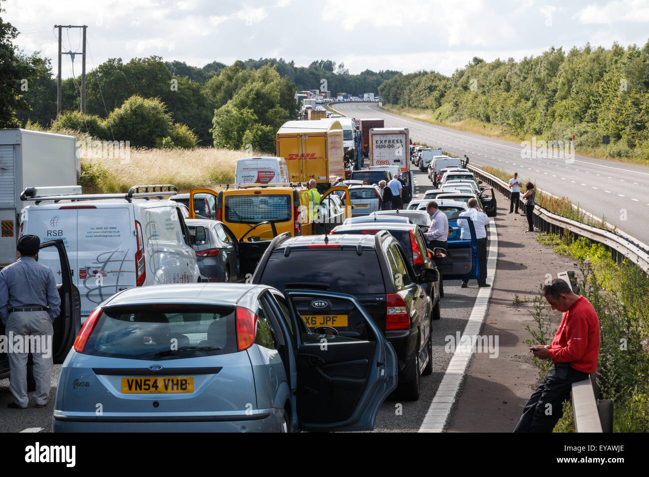 Motorway traffic jam with the road closed.  One carriageway has stationary queuing traffic with the other empty Stock Photo
