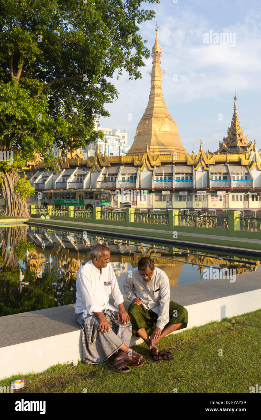 Two men talking with each other with Sule Pagoda in the background Stock Photo