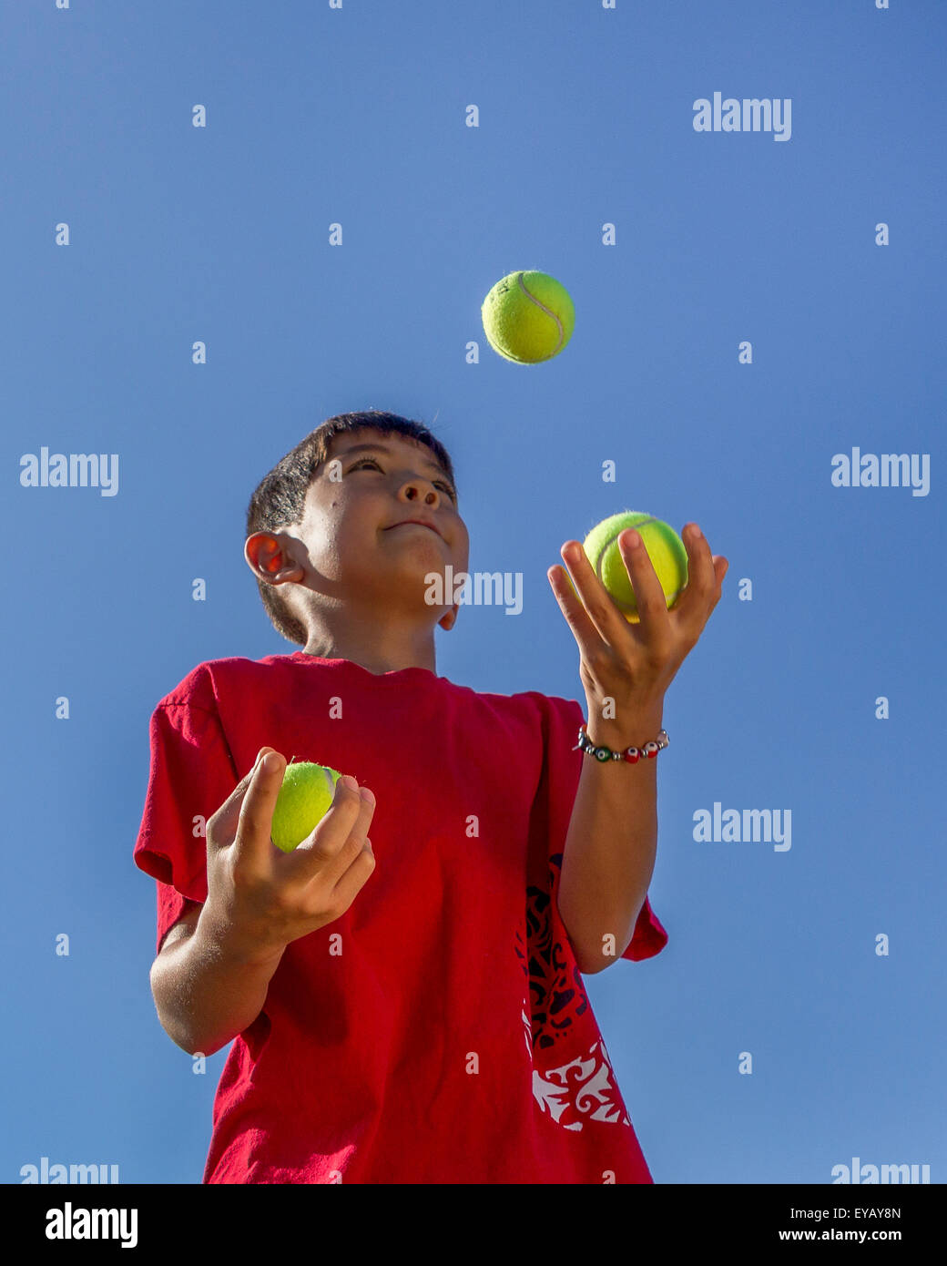 Boy juggles tennis balls Stock Photo Alamy