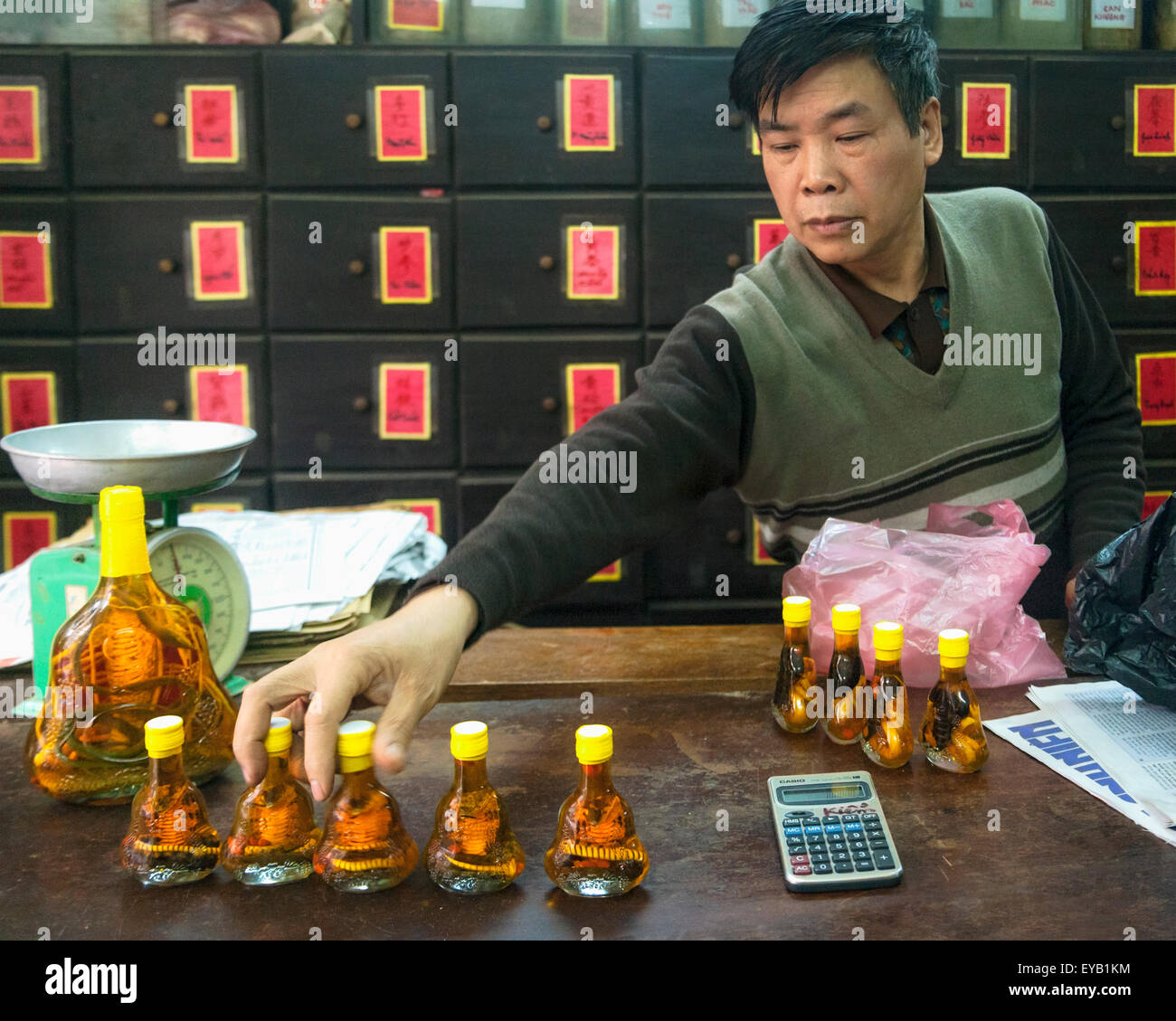 Male Vietnamese shop keeper selling snake wine in Hanoi, Vietnam Stock