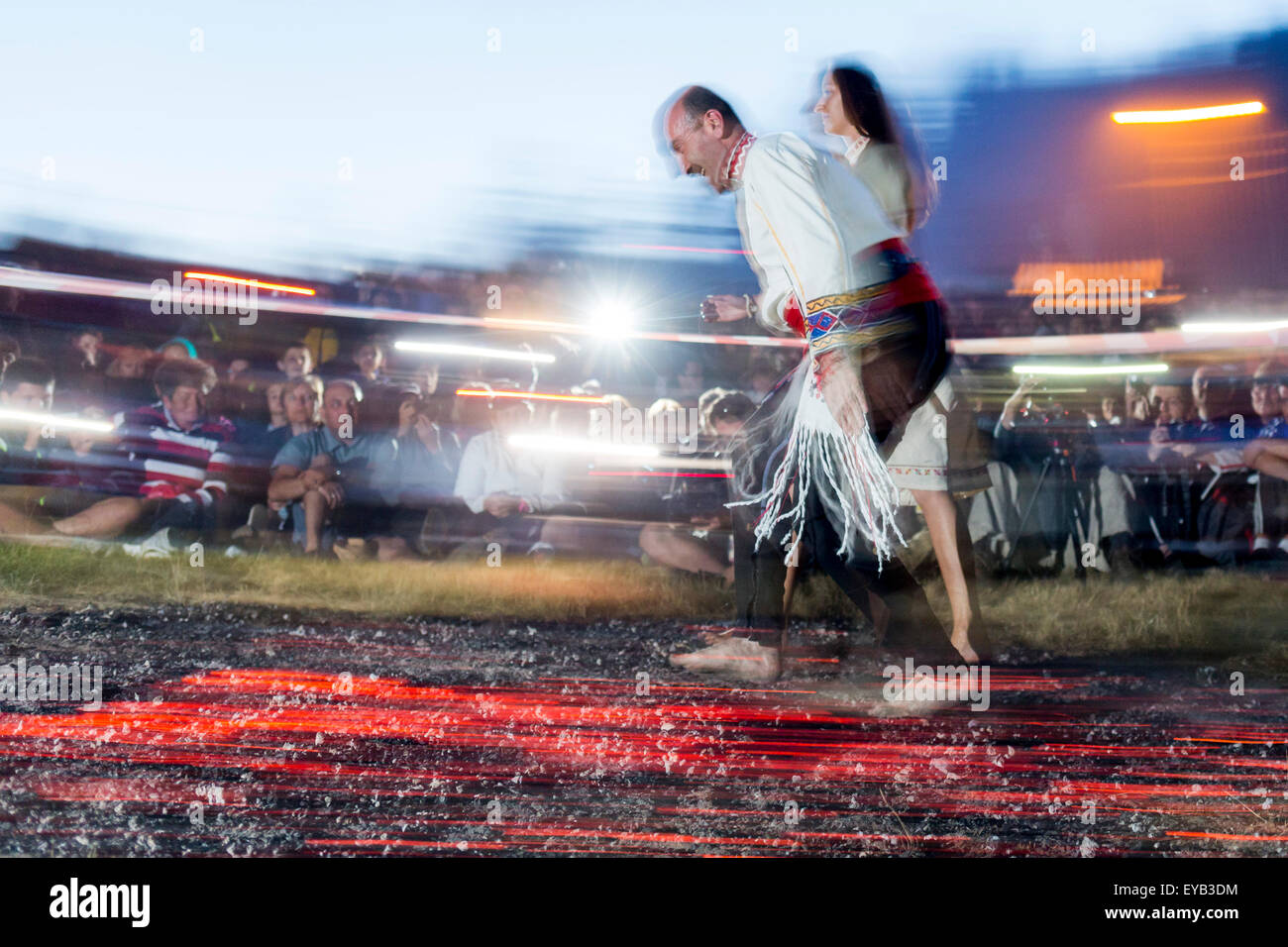 Rozhen, Bulgaria - July 18, 2015: A nestinar is walking on fire during a nestinarstvo show. The fire ritual involves a barefoot  Stock Photo