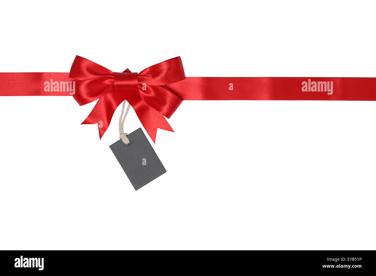 A birthday tag with a red ribbon and bow. The text 'Happy Birthday' on the  top Stock Photo - Alamy