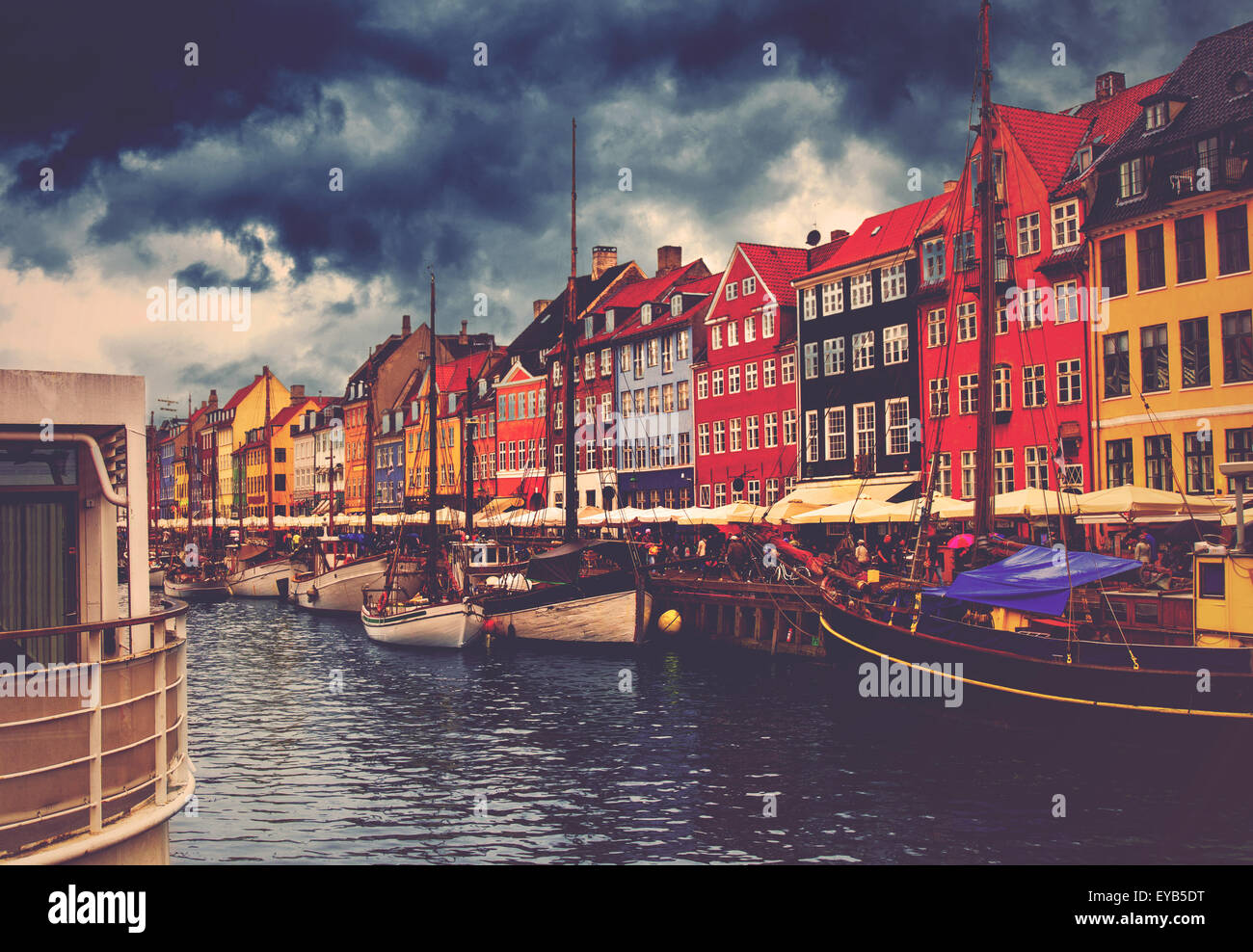 Copenhagen Nyhavn, Retro Toned Image of Canal and District with its Colorful Facades on Cloudy Spring Day Stock Photo
