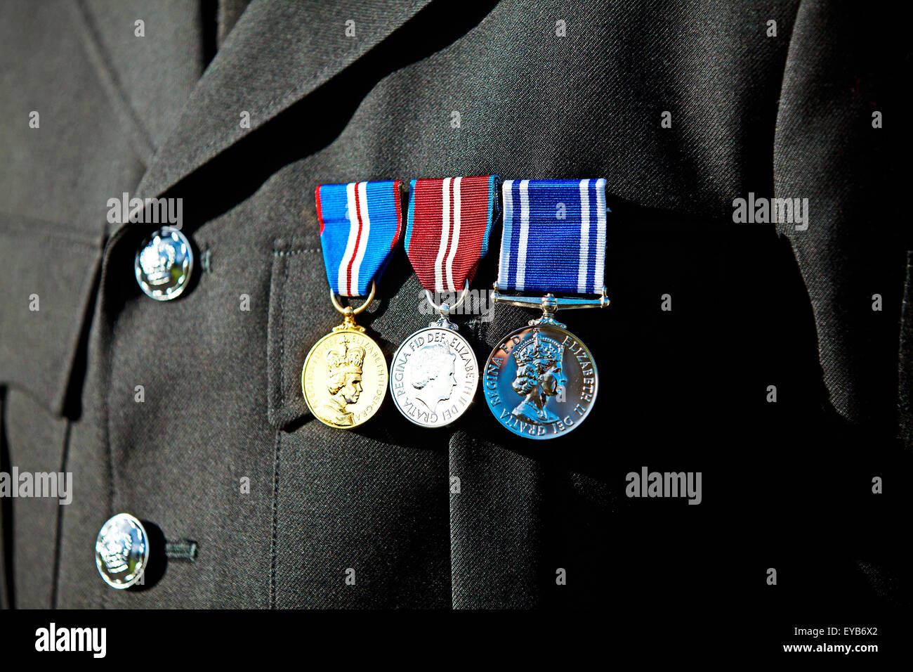 The Police Long Service and Good Conduct medal. The Queens Golden Jubilee Medal and the Queens Diamond Jubilee Medal, pinned to a Policemans tunic Stock Photo
