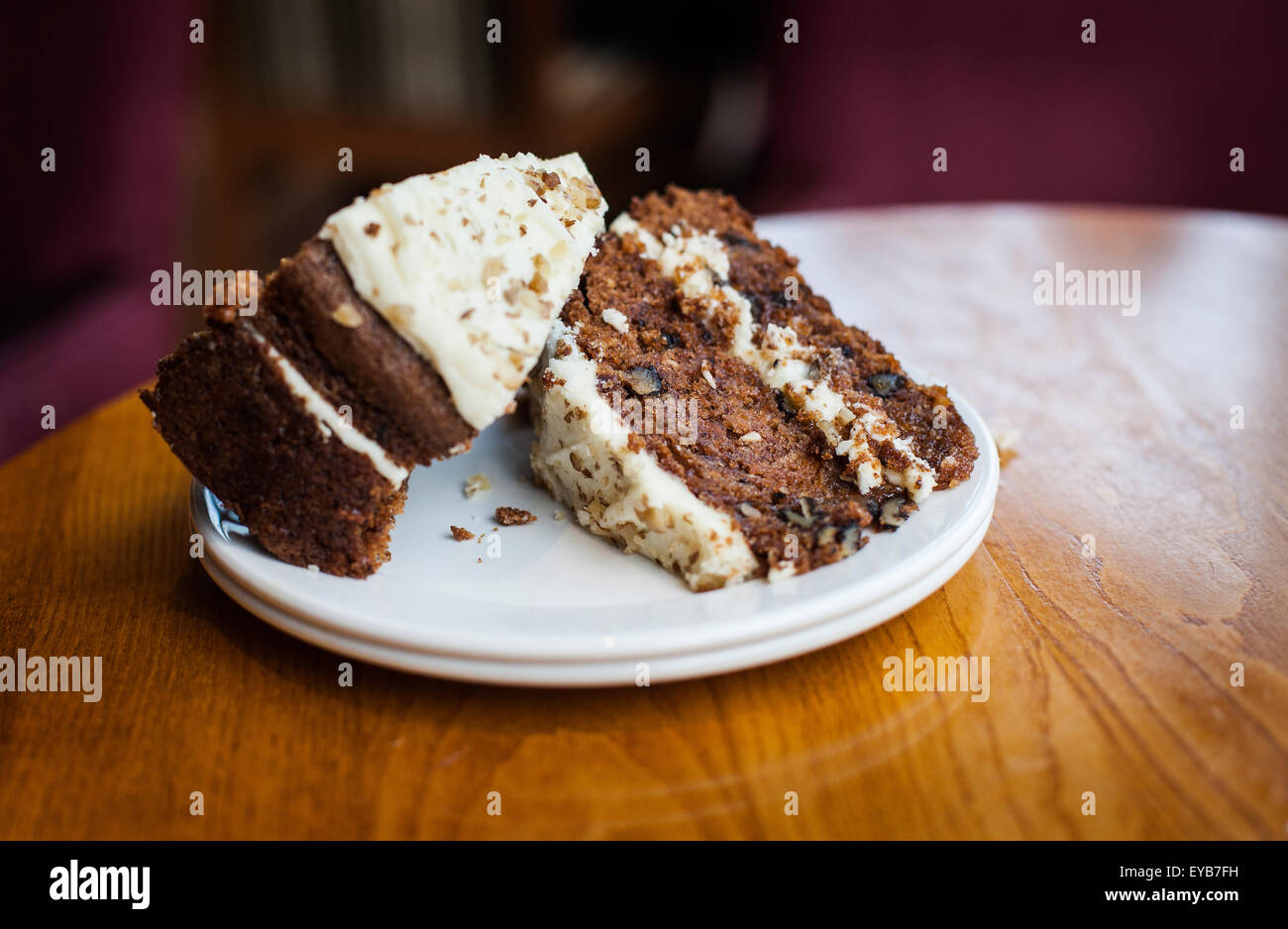 Two slices of delicious looking Carrot cake  on a cafe table waiting to be eaten. Made using an oil based recipe Stock Photo
