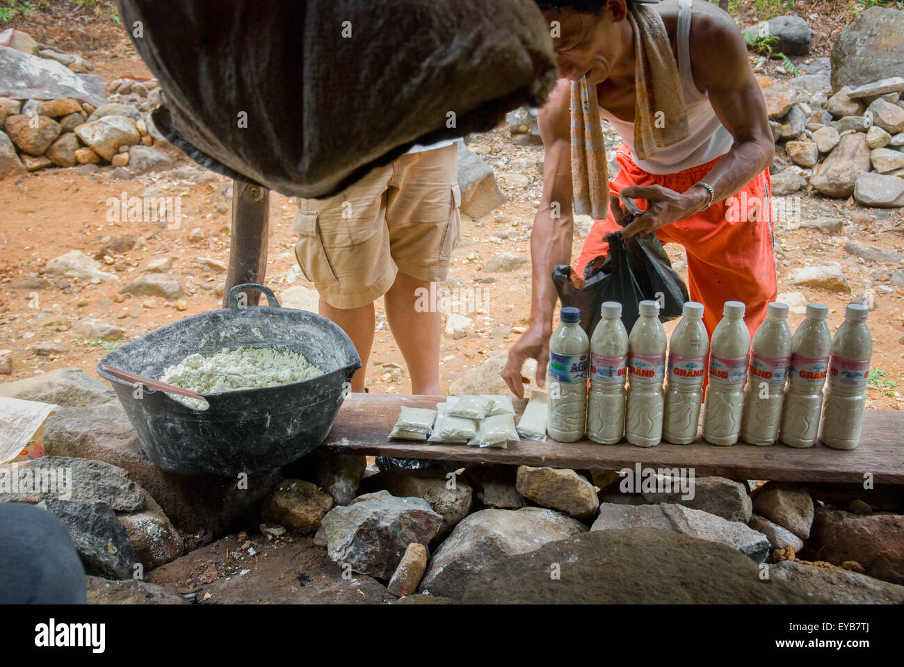 People buying sulfur powder which is believed to have curative effects on skin health, at a vendor in Way Belerang, Kalianda, Lampung, Indonesia. Stock Photo