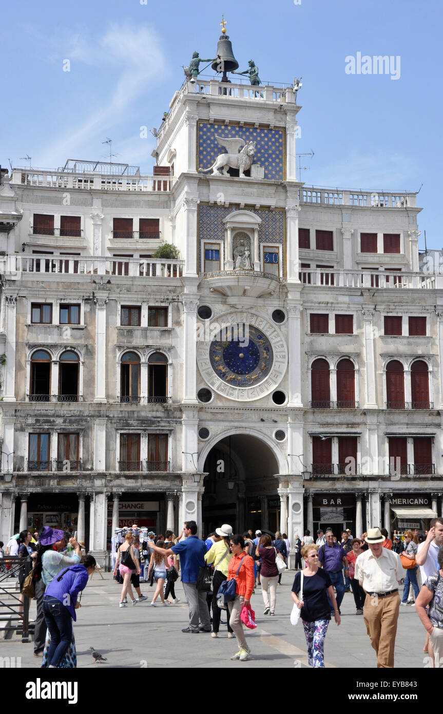 Italy - Venice - Piazza San Marco - the Torre dell'Orologio - famous ornate clock tower - bright sunlight - blue sky - crowds Stock Photo