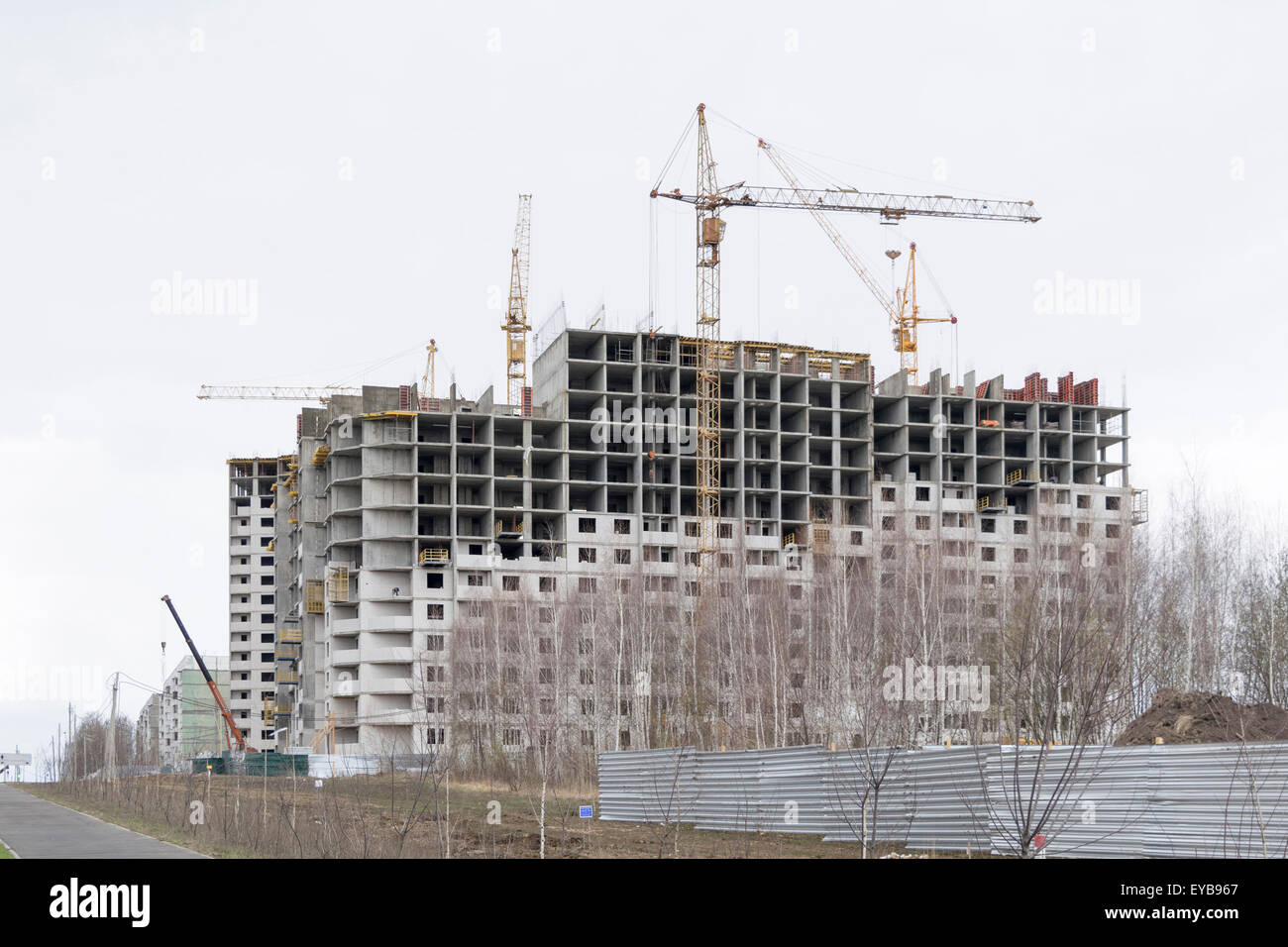 Construction of a new high-rise building. Four tower cranes Stock Photo