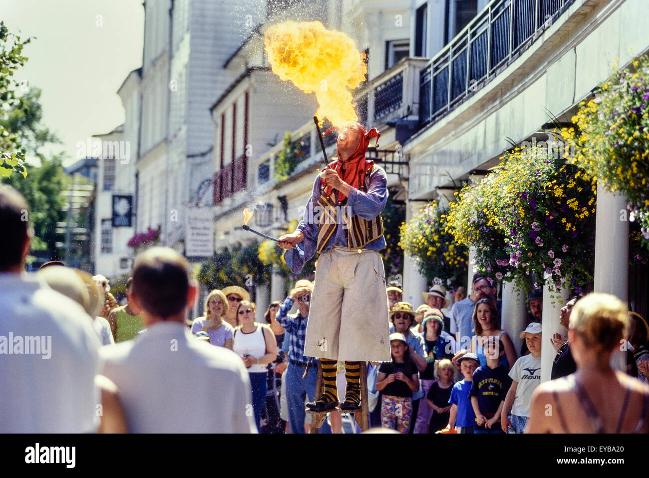 Fire breather on stilts at The Pantiles. Royal Tunbridge Wells. Kent. UK Stock Photo