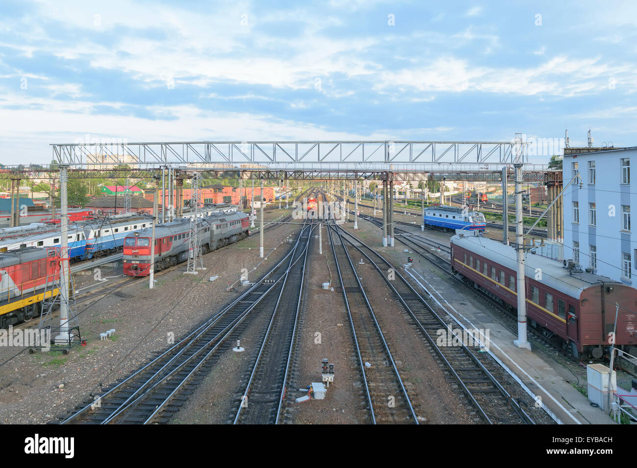 Major train station. Rails stretching into the distance. Flaw detector car is on the tracks near the building. Blue sky Stock Photo