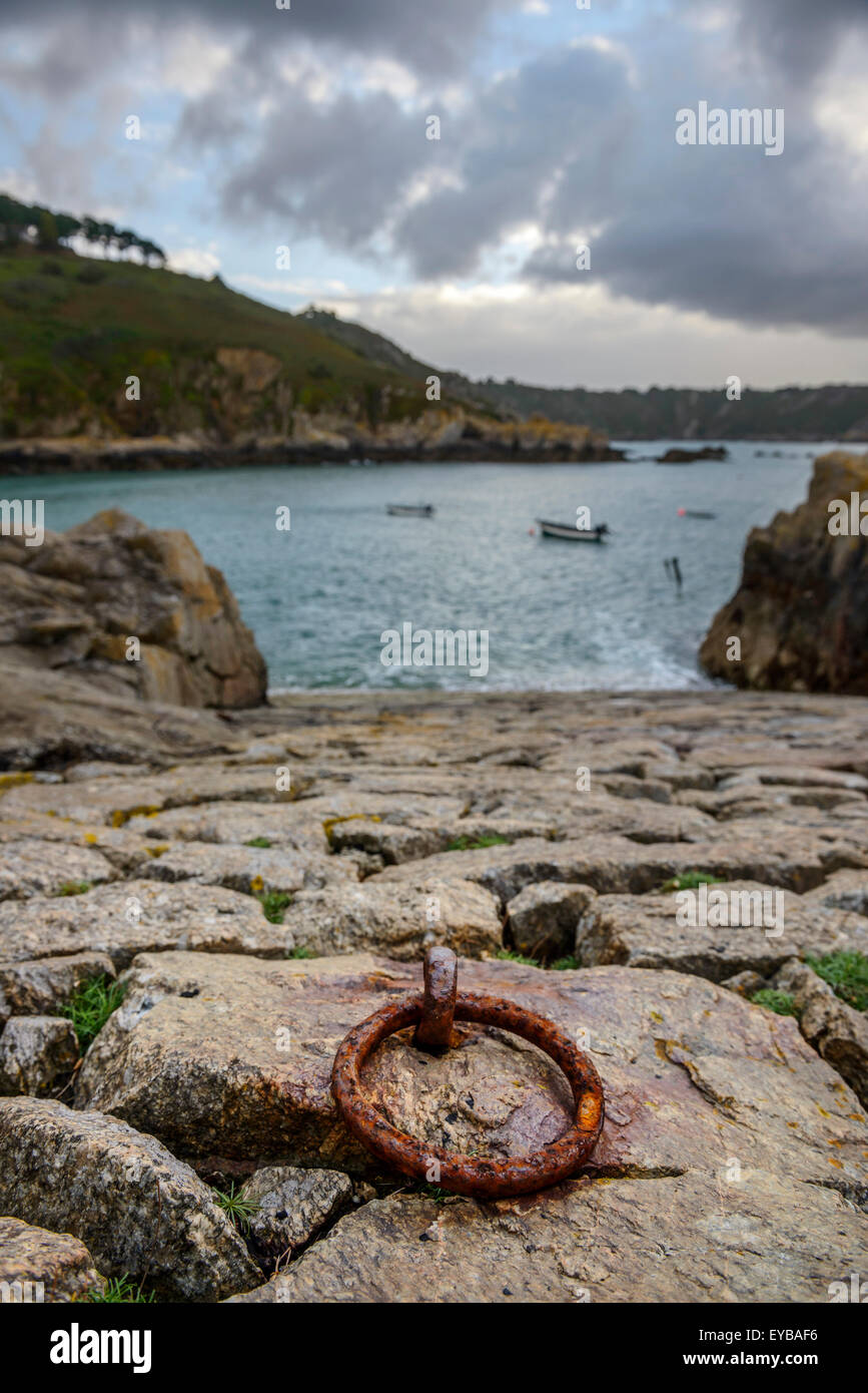 Rusty iron mooring ring on the stone slipway at Saints Bay Harbour, Guernsey, Channel Islands. Stock Photo