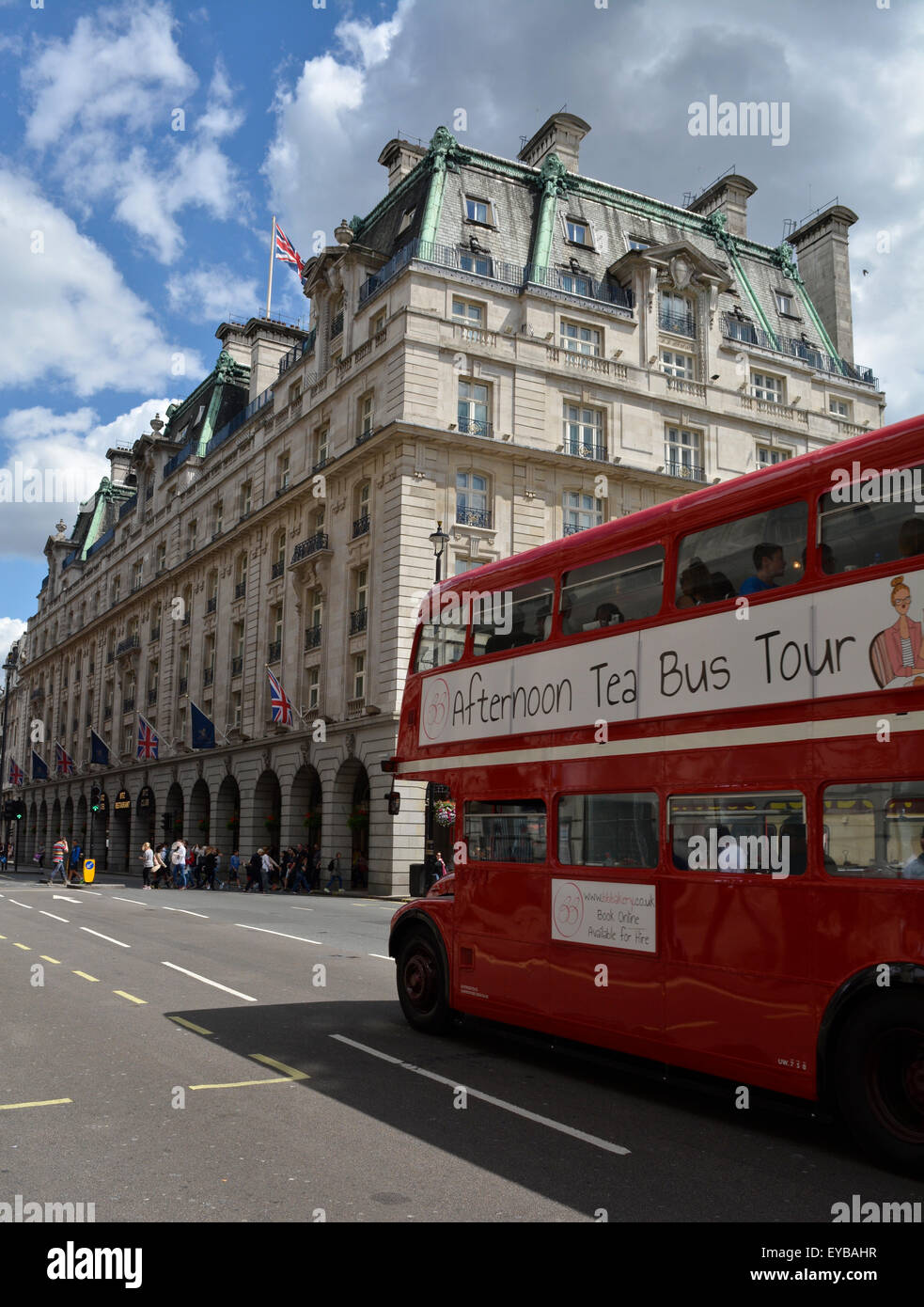 An afternoon tea Routemaster bus tour passes in front of The Ritz Hotel, London, UK Stock Photo