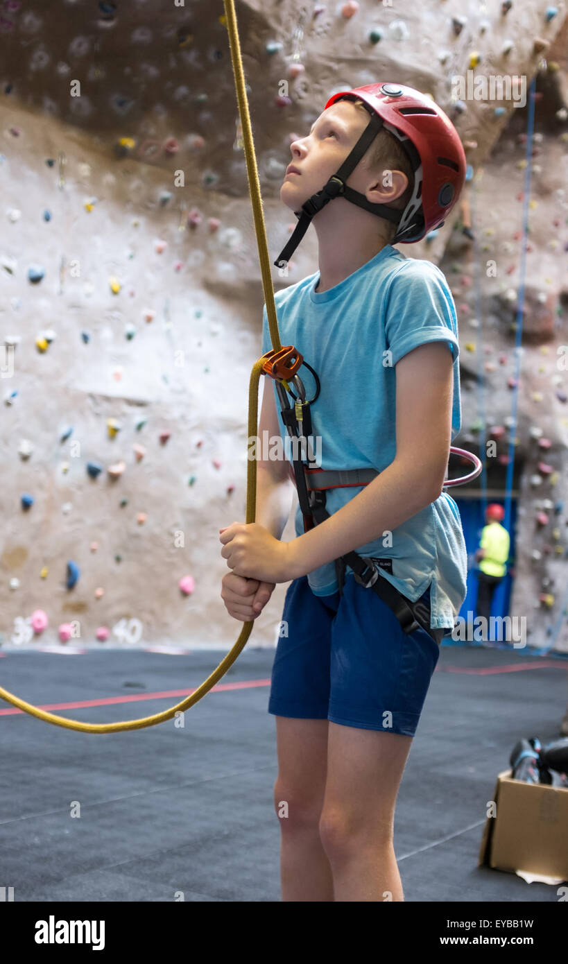 A young boy climbing at an indoor climbing centre wall Stock Photo Alamy