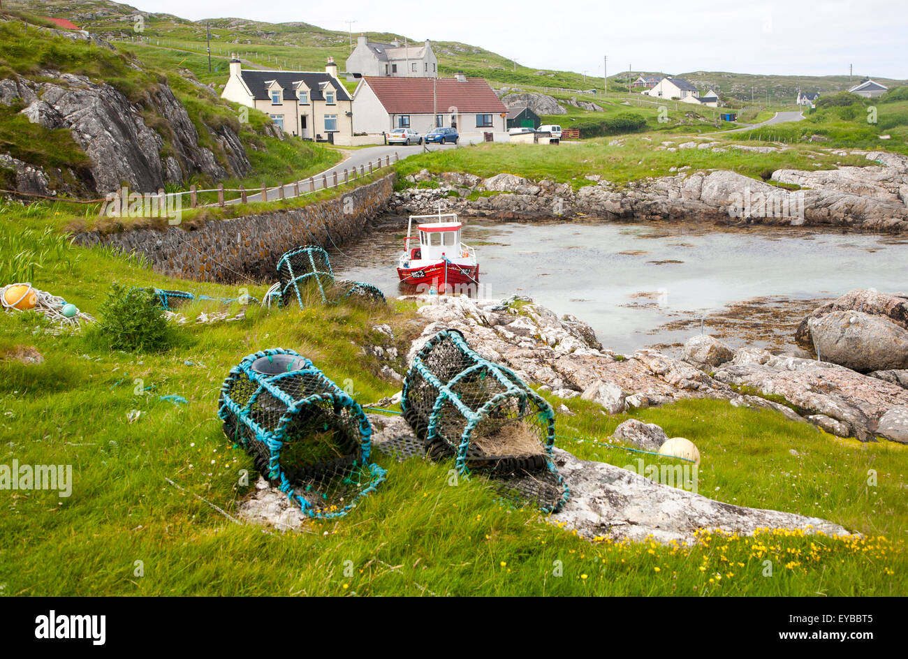 Small fishing boat and lobster pots on the east coast of Barra, Outer Hebrides, Scotland, UK Stock Photo