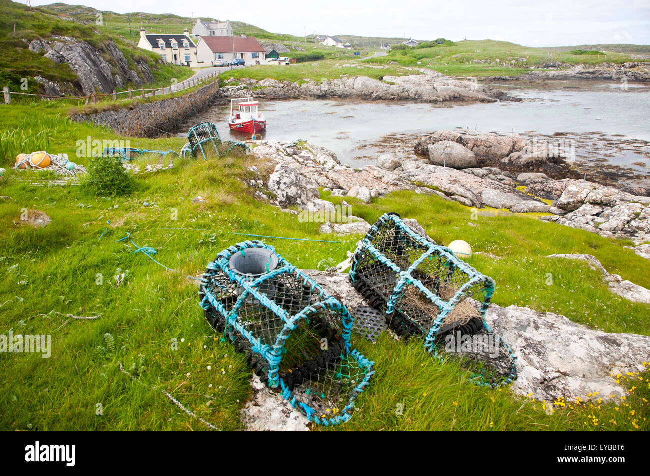 Small fishing boat and lobster pots on the east coast of Barra, Outer Hebrides, Scotland, UK Stock Photo