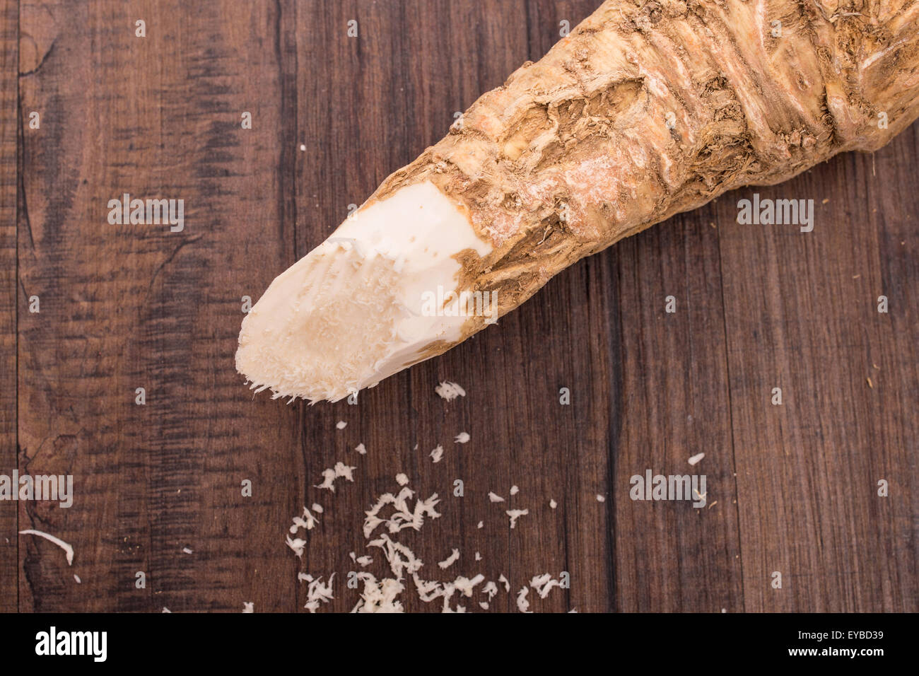 Raw grated horse radish on a brown wooden board Stock Photo