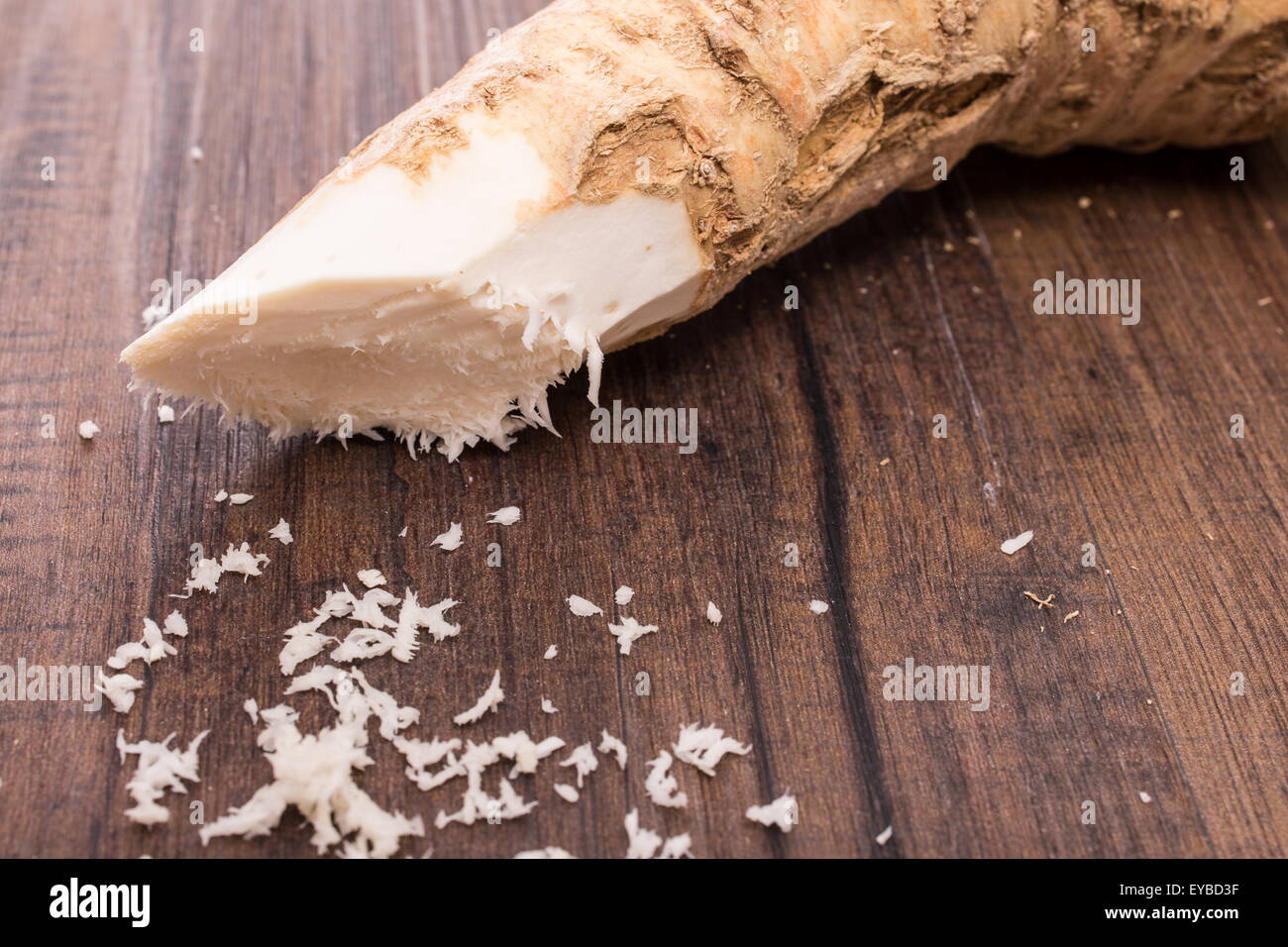 Grated raw horse radish on a wooden table Stock Photo