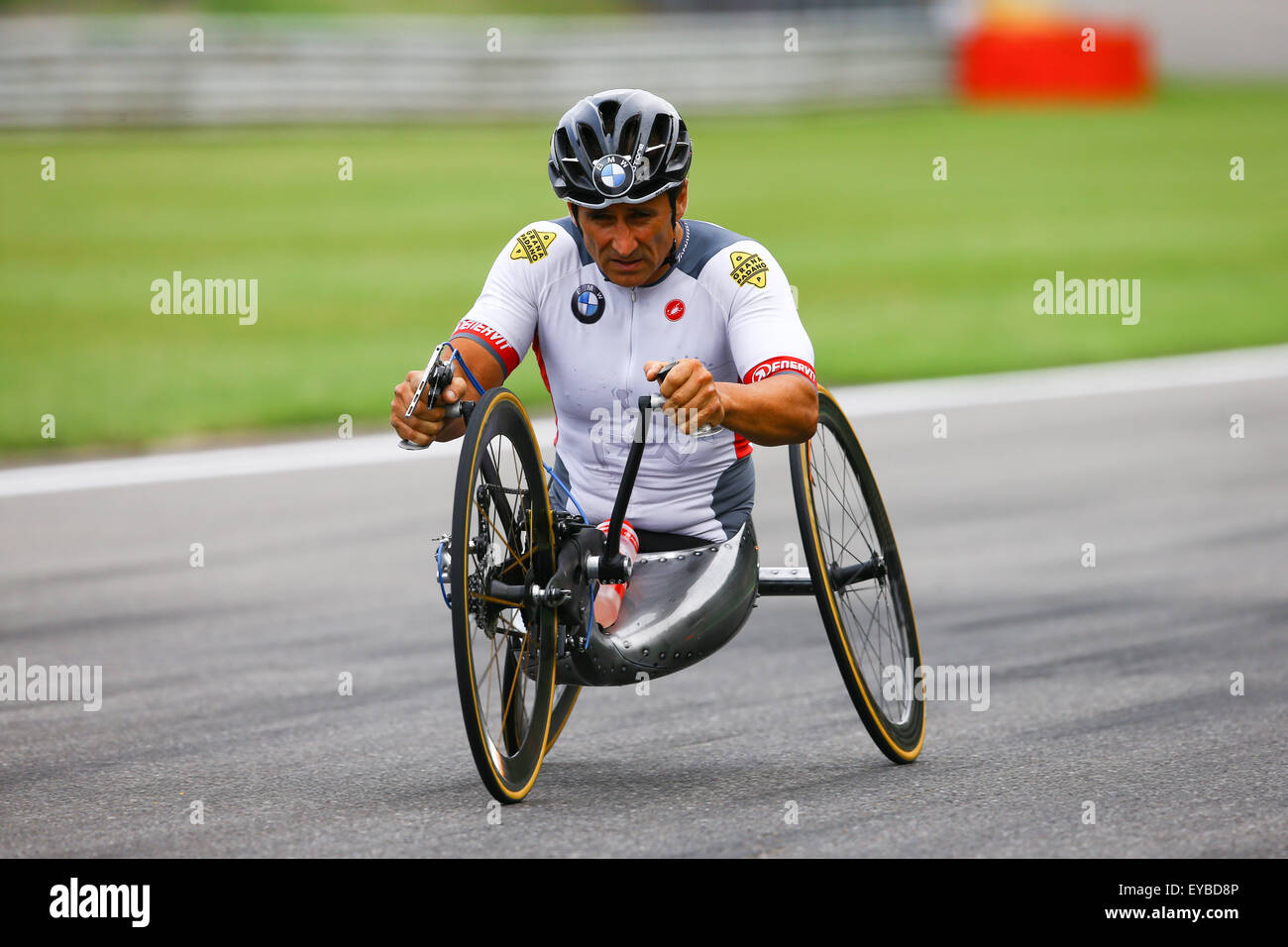 Spa Francorchamps, France. 24th July, 2015. A specially adapted hand-driven bike is demonstrated by Alex Zanardi, who raced against Timo Glock on a regular racing bike. © Action Plus Sports/Alamy Live News Stock Photo