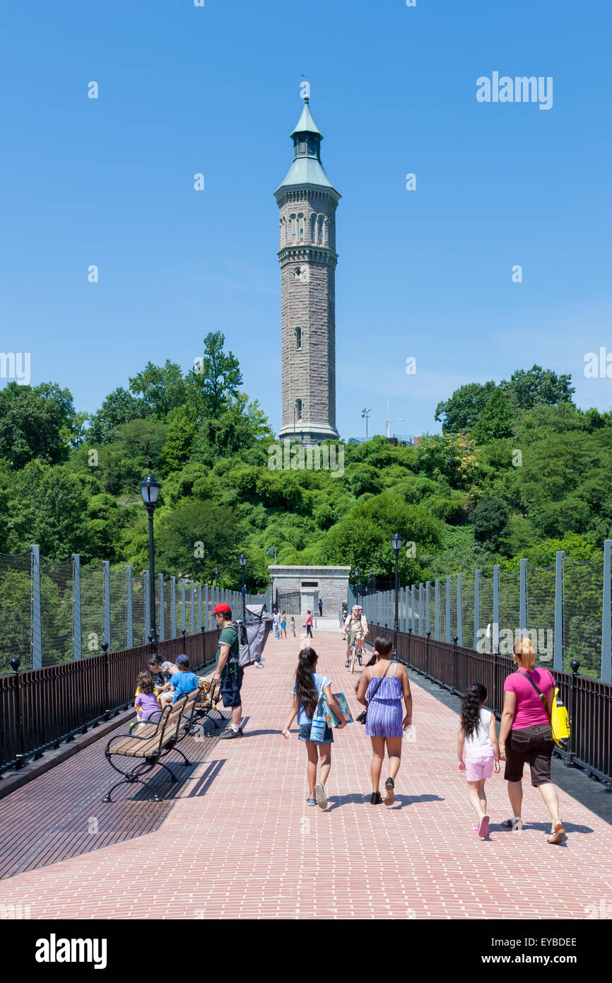 People enjoy the view on the High Bridge leading to the Water Tower in Highbridge Park in Manhattan in New York City. Stock Photo