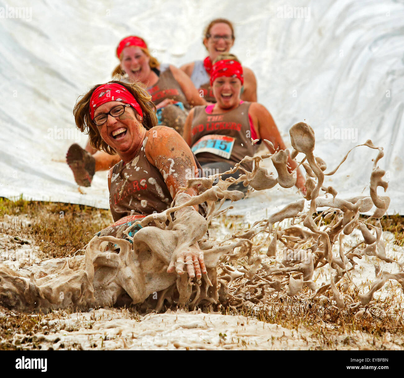 Shelley DiLiberatore and The Mud Lickers slide their way to lots of laughs at the Mud Run for Heart July 25, 2015, Waterford. Stock Photo