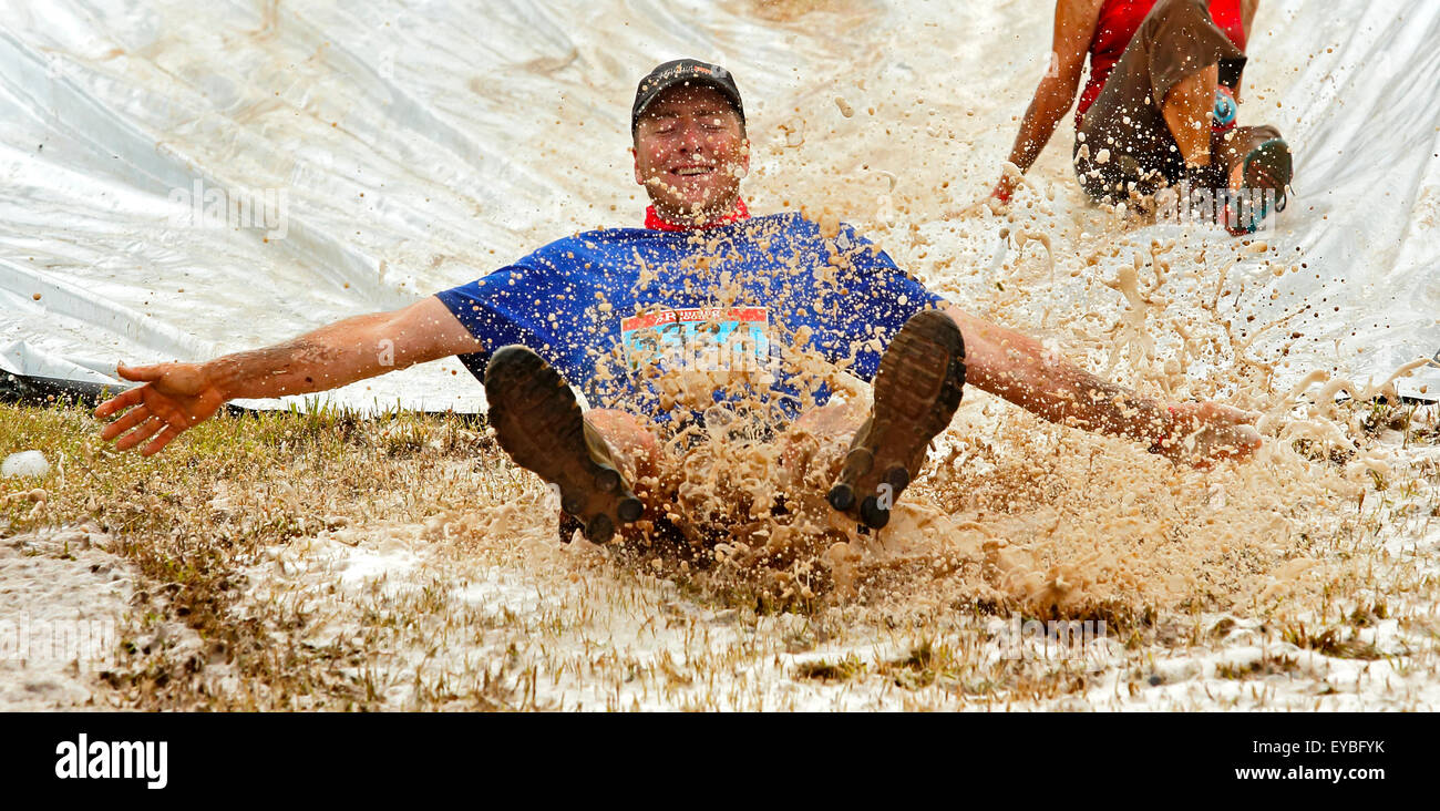 Joe Cannon navigates the soapy, water slide at the Mud Run for Heart July 25, 2015, Waterford, New Brunswick, Canada. Stock Photo