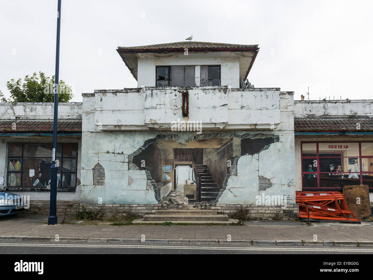 Street scene of realistic, convincing trompe l'oeil painting on an old roadside building wall in Swanage, Isle of Purbeck, Dorset, south-west England Stock Photo